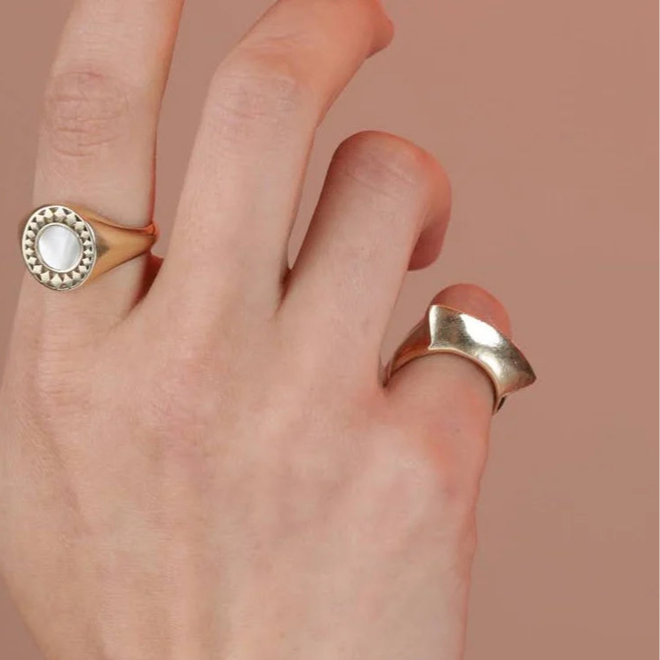 Silver ring on a light gray background