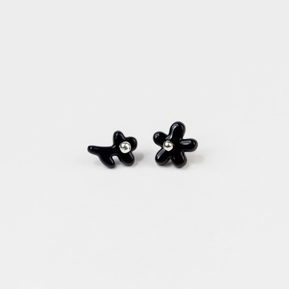 Black flower-shaped earrings on a white background
