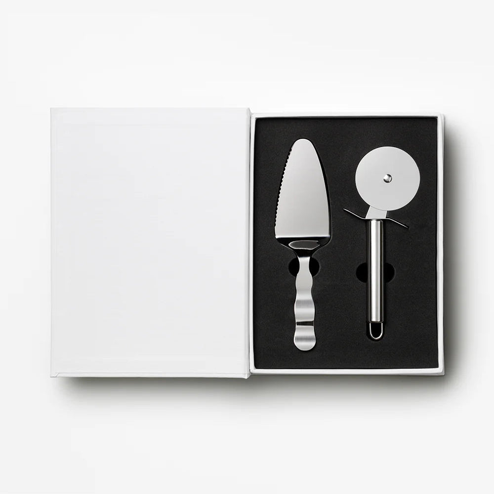 Set of cake server and pizza cutter in a black box on a white background