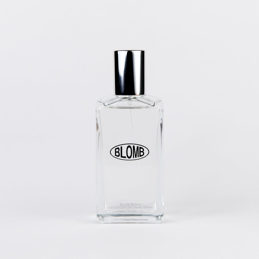 Perfume bottle with silver cap and the word BLOMB on the front