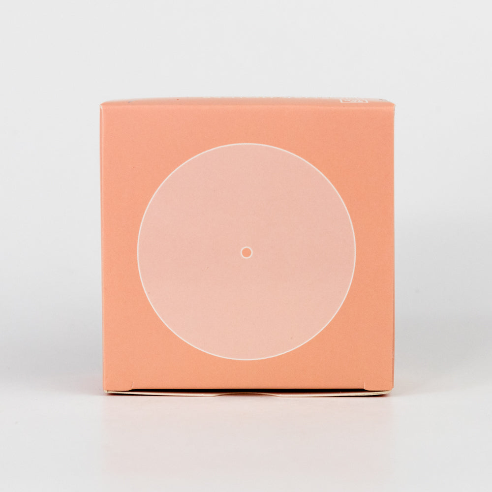 Coral-colored square box with a circular transparent window on a light gray background