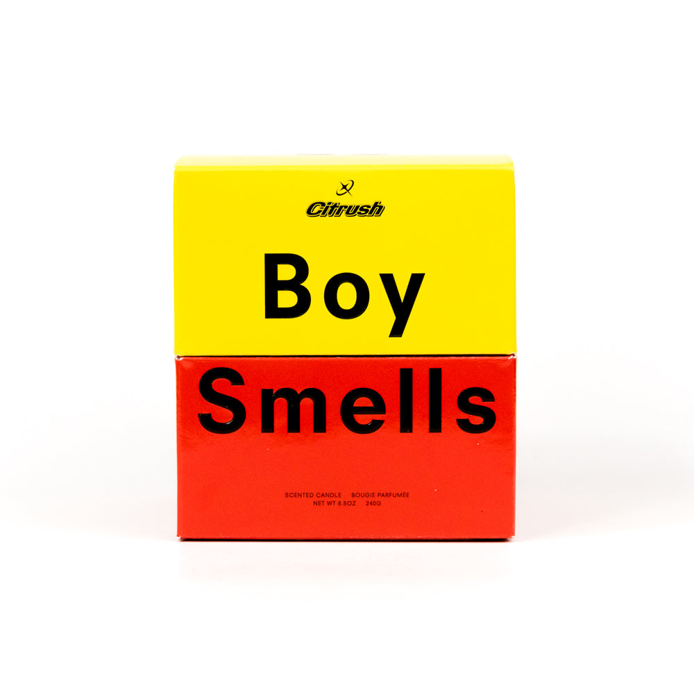 Candle in a black container with a colorful label on a white background