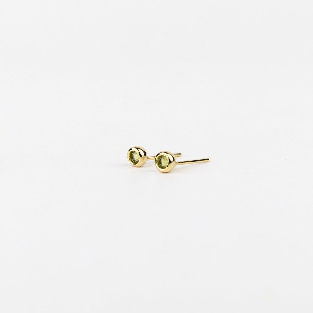 Gold stud earrings on a white background