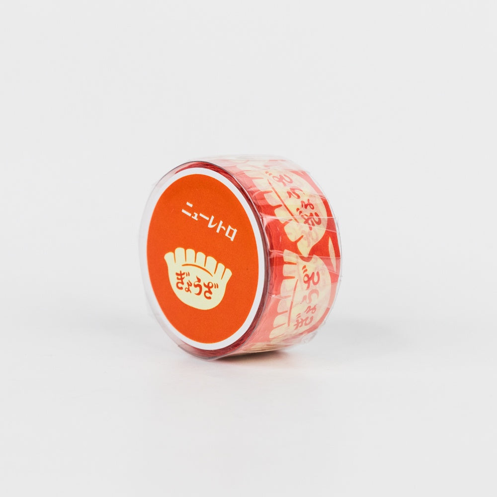 Small roll of red patterned tape with red label on a white background
