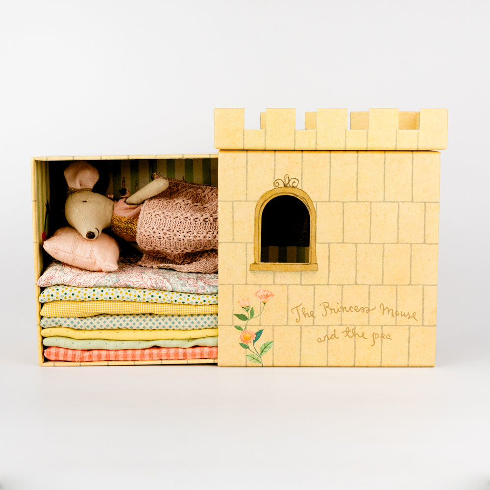 Wooden castle toy with a plush mouse toy in a dress on a white background