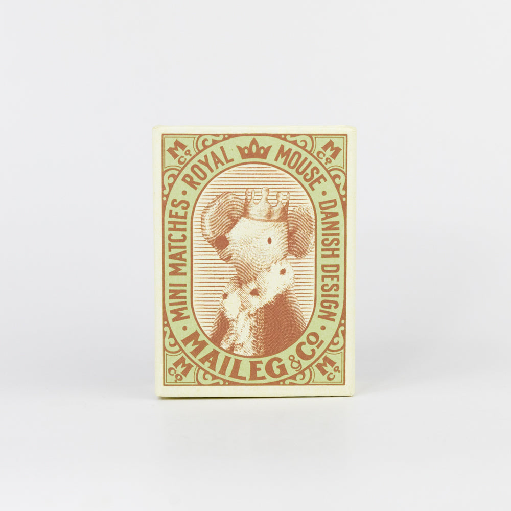 Stuffed mouse toy in a striped box on a white background