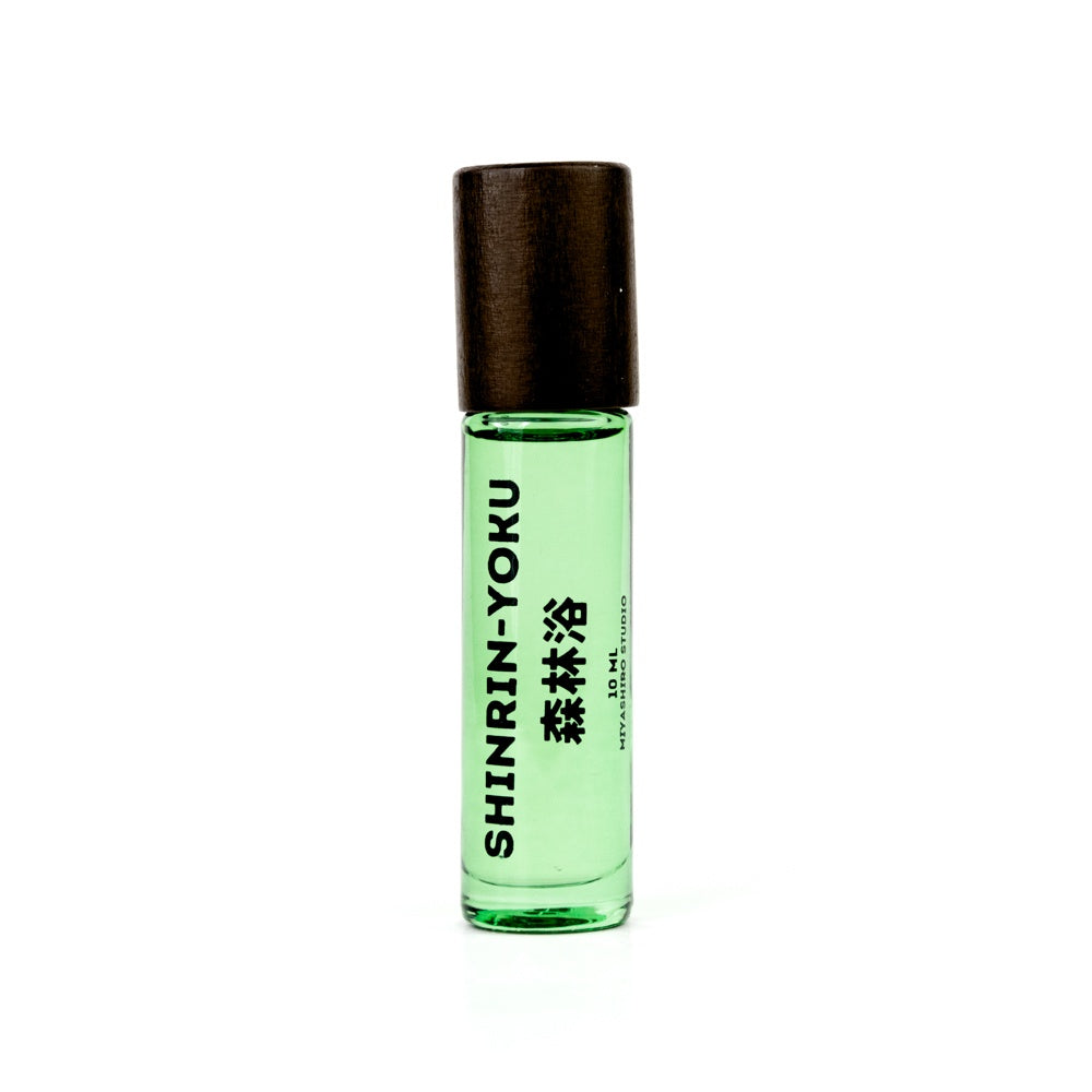 Green rollerball bottle with black cap on a white background