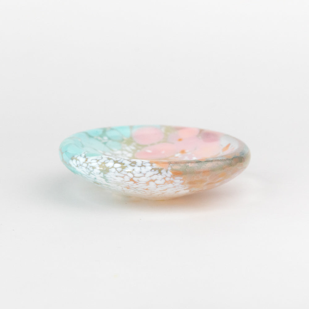 Decorative glass bowl with floral design on a white background