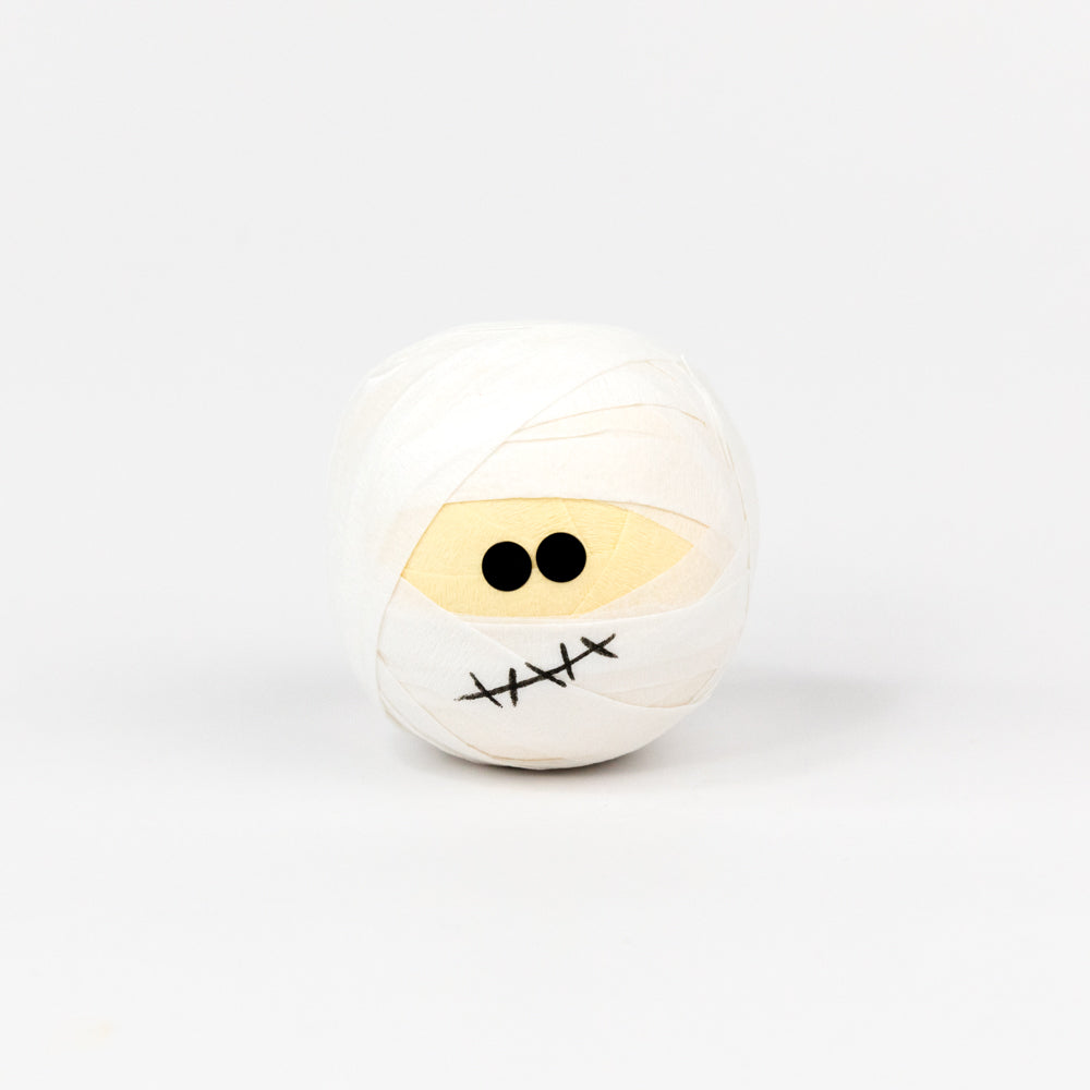 White ball with black eyes and a mouth on a white background
